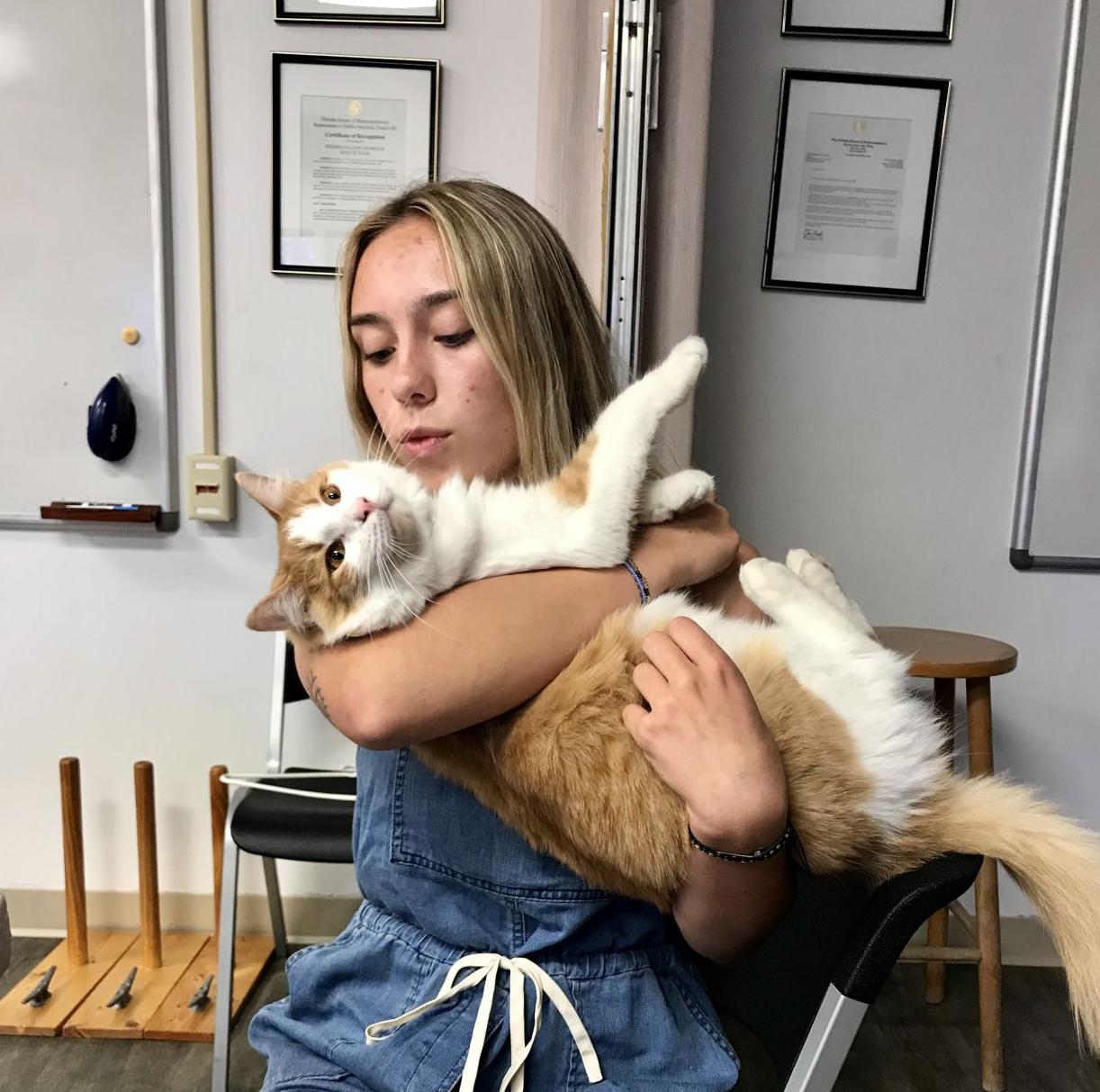 Pet of the Issue: Photo of Skyway the Cat and Student